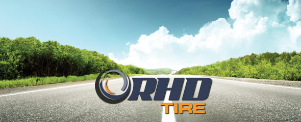 Open road in spring with RHD Tire logo